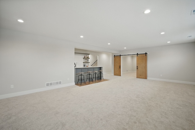 18167 Alderleaf Dr, Clive, IA 50325 - below grade area featuring recessed lighting, light colored carpet, a barn door, and baseboards