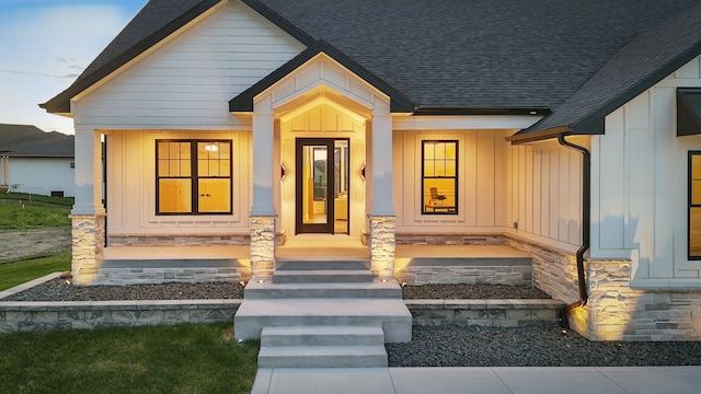 18167 Alderleaf Dr, Clive, IA 50325 - view of front of house with board and batten siding, a shingled roof, and a porch