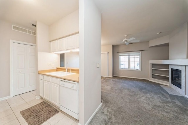 kitchen with a sink, white cabinetry, white dishwasher, visible vents, and ceiling fan