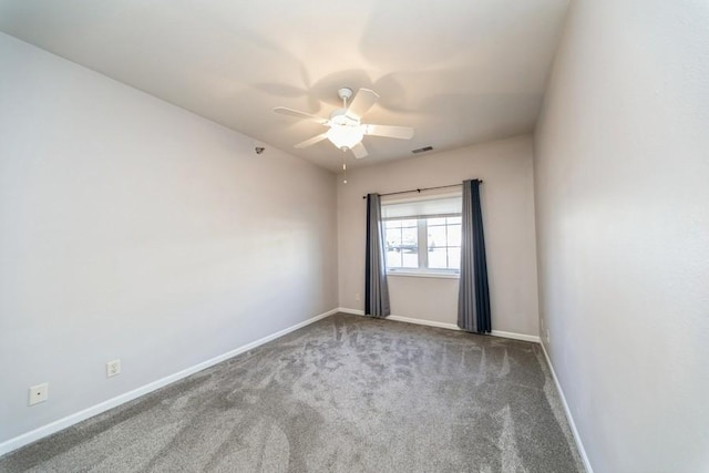 empty room featuring visible vents, carpet, baseboards, and ceiling fan