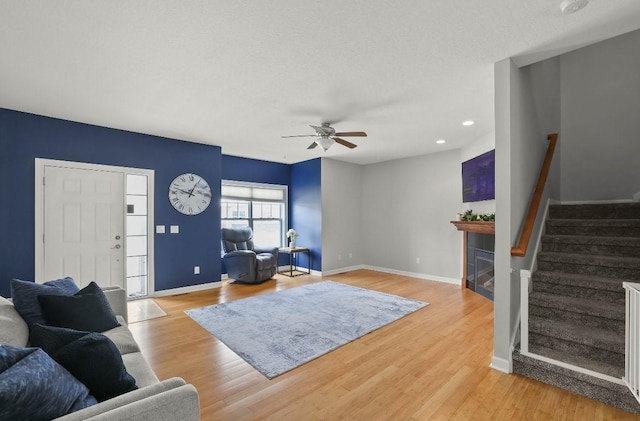 193 63rd St Unit 20107, West Des Moines, IA 50266 - living room with stairs, a ceiling fan, a fireplace, baseboards, and recessed lighting