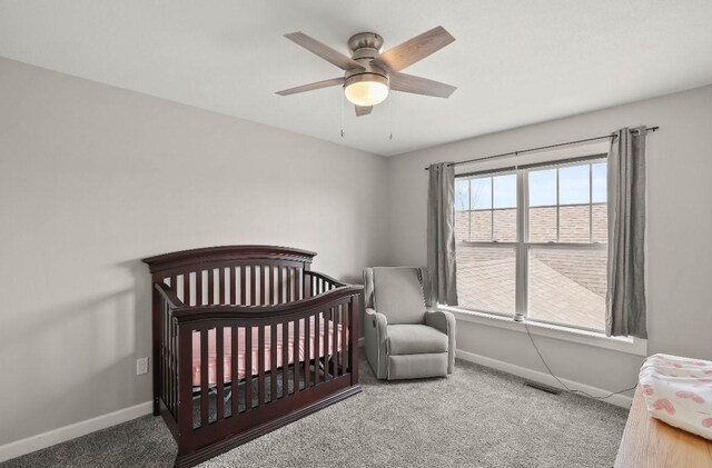 193 63rd St Unit 20107, West Des Moines, IA 50266 - carpeted bedroom with baseboards, ceiling fan, and a nursery area