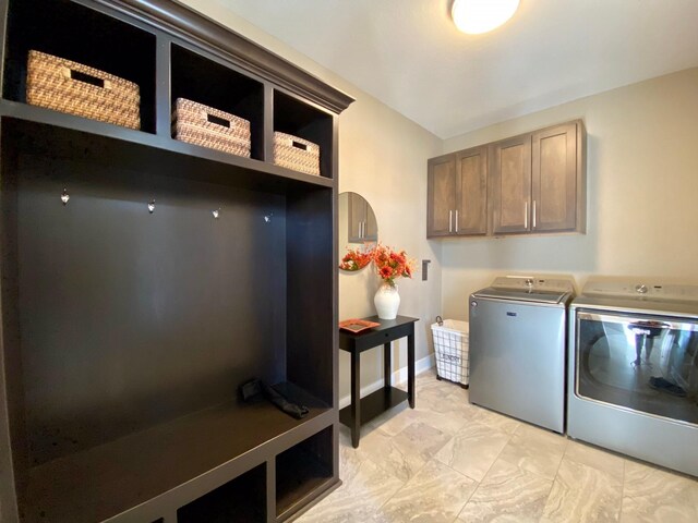 17595 Aurora Dr, Clive, IA 50325 - laundry room featuring cabinet space, separate washer and dryer, light marble finish flooring, and baseboards