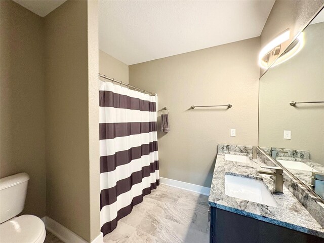 17595 Aurora Dr, Clive, IA 50325 - full bathroom featuring toilet, double vanity, baseboards, and a shower with curtain