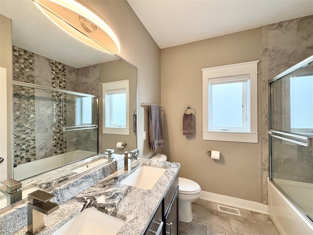 17595 Aurora Dr, Clive, IA 50325 - full bath with baseboards, healthy amount of natural light, marble finish flooring, and double vanity