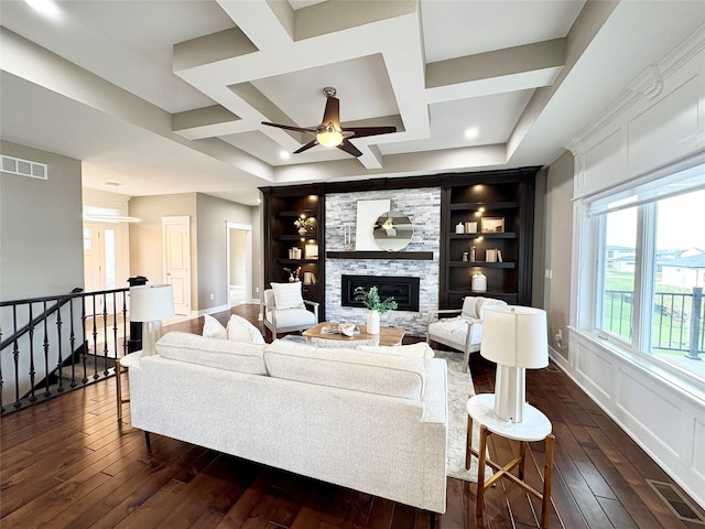 17595 Aurora Dr, Clive, IA 50325 - living room with dark wood-type flooring, baseboards, a ceiling fan, coffered ceiling, and a stone fireplace