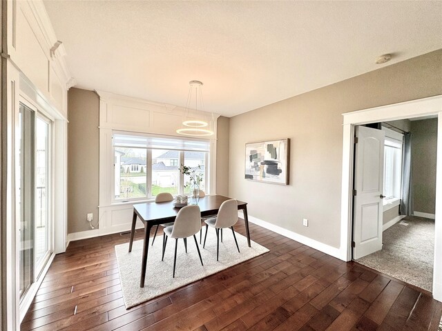 17595 Aurora Dr, Clive, IA 50325 - dining area featuring dark wood-style floors, baseboards, and a chandelier