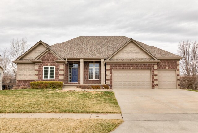 craftsman house with a front lawn, an attached garage, brick siding, and concrete driveway