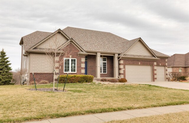 craftsman inspired home featuring brick siding, a garage, and a front lawn