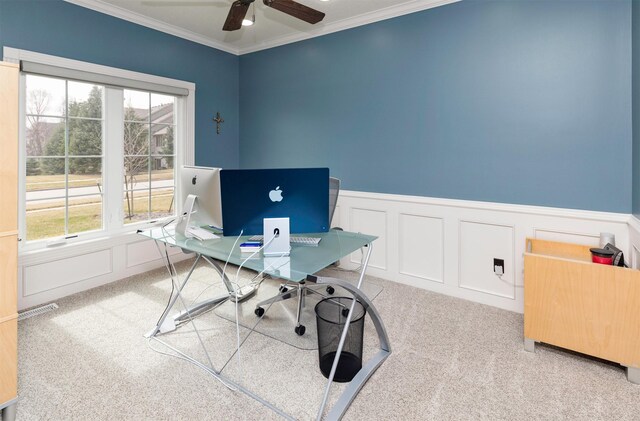 office area featuring a wainscoted wall, carpet floors, ornamental molding, and a ceiling fan