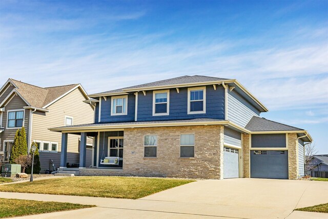 view of front of home featuring cooling unit, concrete driveway, stone siding, a front yard, and a porch