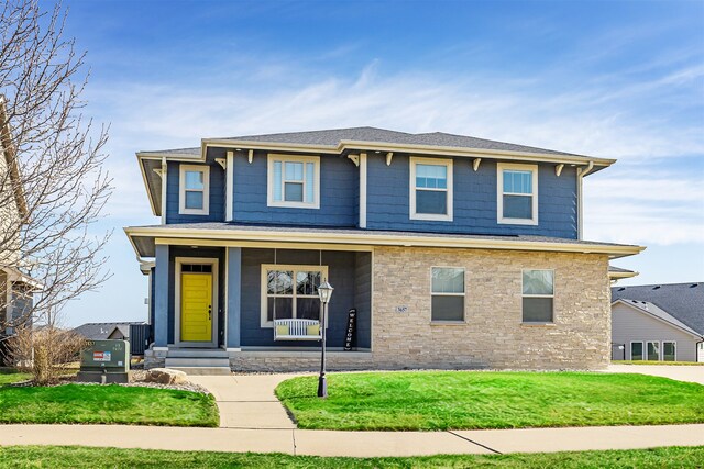 view of front of property with a porch and a front yard