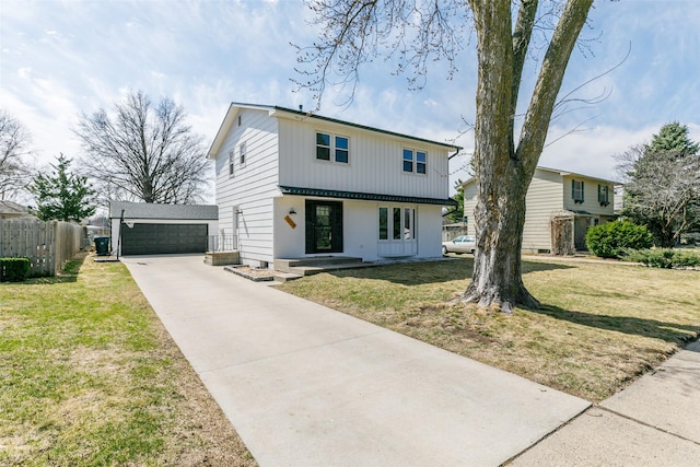 view of front of home featuring an outbuilding, fence, a front lawn, and a garage