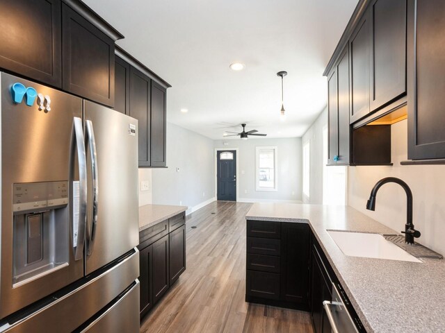 613 E 8th St N, Newton, IA 50208 - kitchen featuring stainless steel fridge, a sink, recessed lighting, light wood finished floors, and ceiling fan
