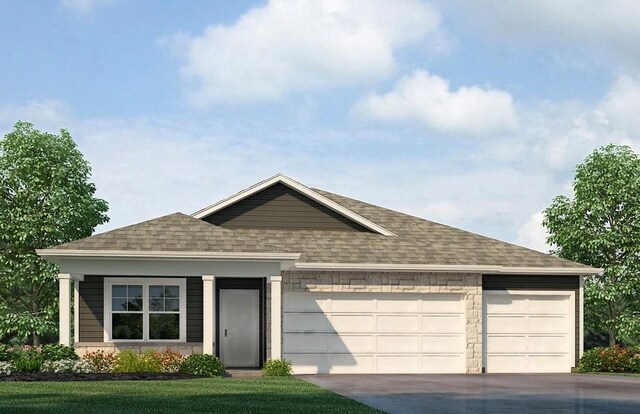 view of front of home featuring driveway, a shingled roof, and an attached garage
