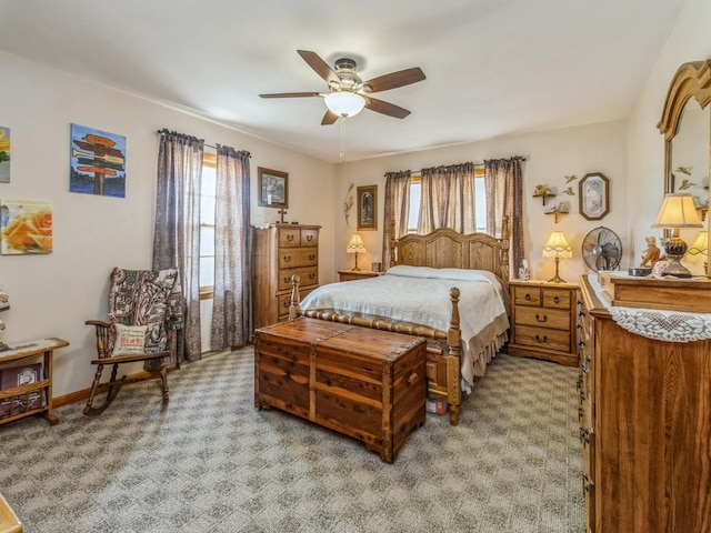 bedroom with multiple windows, ceiling fan, and baseboards
