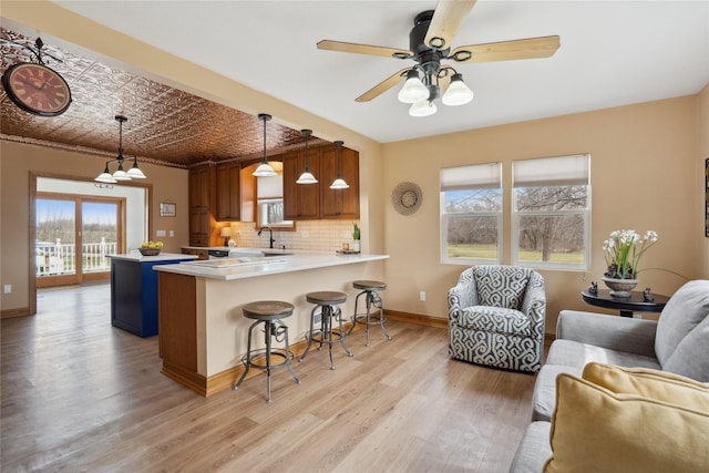 321 W Maple St, Roland, IA 50236 - kitchen with light countertops, tasteful backsplash, an ornate ceiling, baseboards, and a peninsula