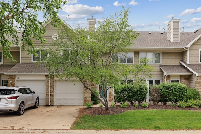 811 Burr Oaks Dr Unit 1110, West Des Moines, IA 50266 - multi unit property with stone siding, a shingled roof, a chimney, concrete driveway, and an attached garage