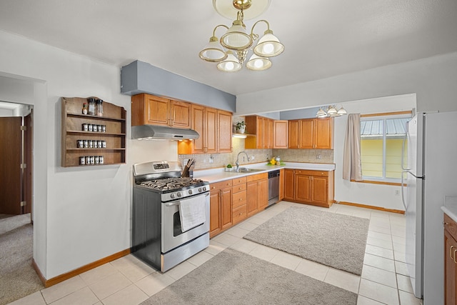 400 Center Ave S, Mitchellville, IA 50169 - kitchen with stainless steel appliances, a chandelier, under cabinet range hood, a sink, and open shelves