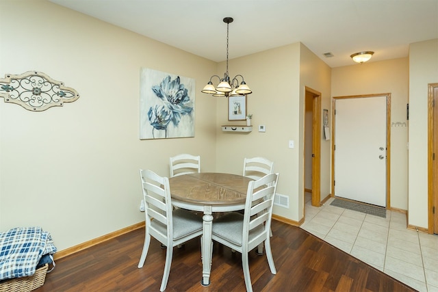 2819 Ashland Ct, Altoona, IA 50009 - dining room with a chandelier, baseboards, and wood finished floors