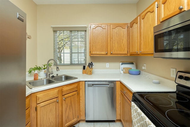 2819 Ashland Ct, Altoona, IA 50009 - kitchen featuring stainless steel appliances, a sink, light countertops, and light tile patterned flooring