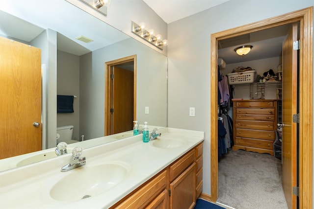 2819 Ashland Ct, Altoona, IA 50009 - full bathroom featuring double vanity and a spacious closet