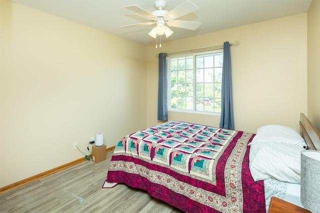 2819 Ashland Ct, Altoona, IA 50009 - bedroom with wood finished floors, baseboards, and ceiling fan