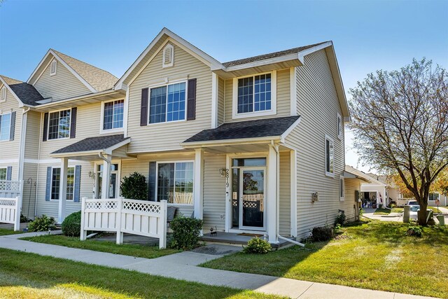 2819 Ashland Ct, Altoona, IA 50009 - townhome / multi-family property with a front lawn and a shingled roof
