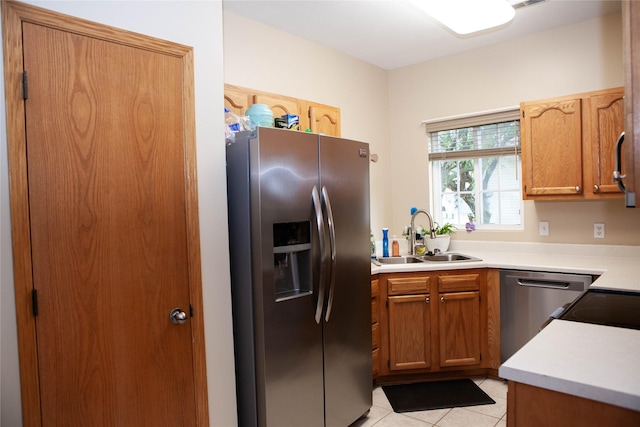 2819 Ashland Ct, Altoona, IA 50009 - kitchen with appliances with stainless steel finishes, light tile patterned floors, light countertops, and brown cabinetry