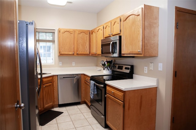 2819 Ashland Ct, Altoona, IA 50009 - kitchen with appliances with stainless steel finishes, light tile patterned floors, and light countertops