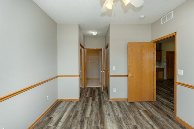 1325 SE Florence Dr Unit 207, Waukee, IA 50263 - spare room featuring wood finished floors, a ceiling fan, baseboards, a textured ceiling, and a smoke detector