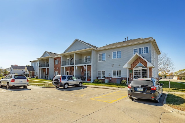 1325 SE Florence Dr Unit 207, Waukee, IA 50263 - view of front facade with brick siding and uncovered parking