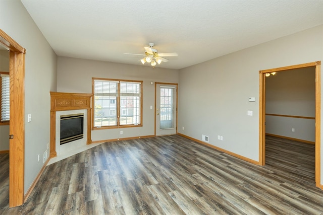 1325 SE Florence Dr Unit 207, Waukee, IA 50263 - unfurnished living room with ceiling fan, wood finished floors, baseboards, and a fireplace