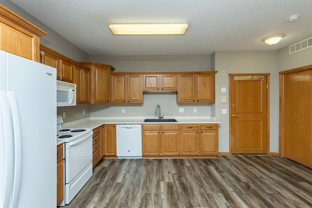 1325 SE Florence Dr Unit 207, Waukee, IA 50263 - kitchen featuring white appliances, a sink, dark wood finished floors, light countertops, and brown cabinetry