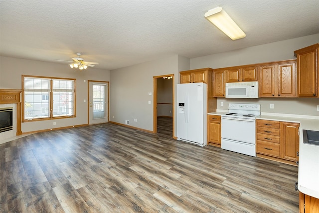 1325 SE Florence Dr Unit 207, Waukee, IA 50263 - kitchen with white appliances, wood finished floors, ceiling fan, light countertops, and open floor plan