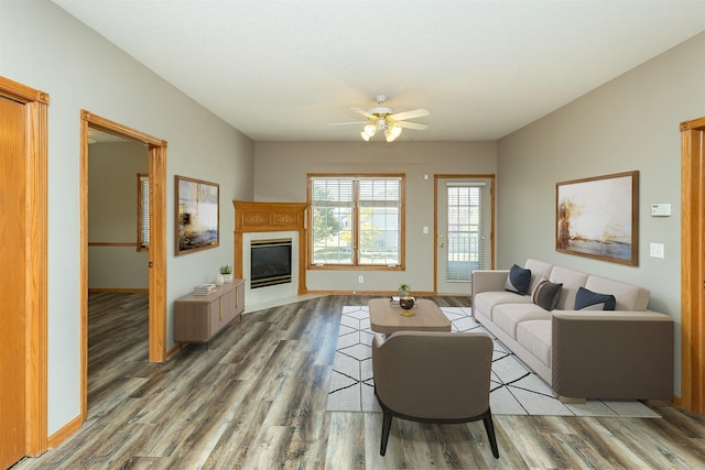 1325 SE Florence Dr Unit 207, Waukee, IA 50263 - living room featuring ceiling fan, wood finished floors, a fireplace, and baseboards
