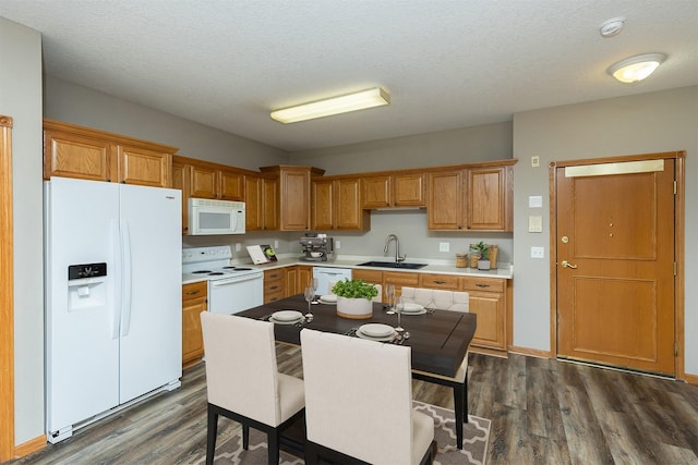 1325 SE Florence Dr Unit 207, Waukee, IA 50263 - kitchen featuring white appliances, a sink, dark wood finished floors, light countertops, and a textured ceiling