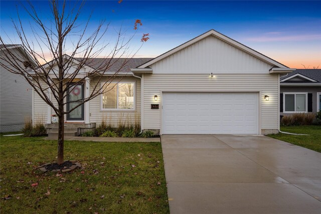 ranch-style home with a front yard, concrete driveway, and a garage