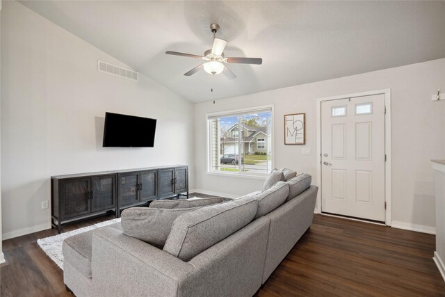 living area with dark wood-style floors, lofted ceiling, baseboards, visible vents, and ceiling fan