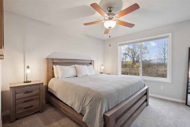 carpeted bedroom with baseboards and a ceiling fan