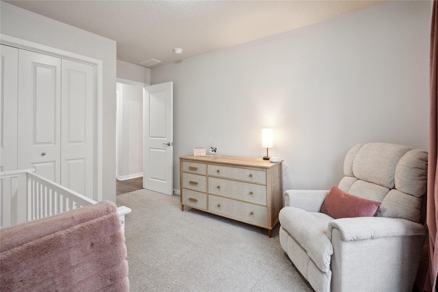 bedroom featuring light carpet and a closet