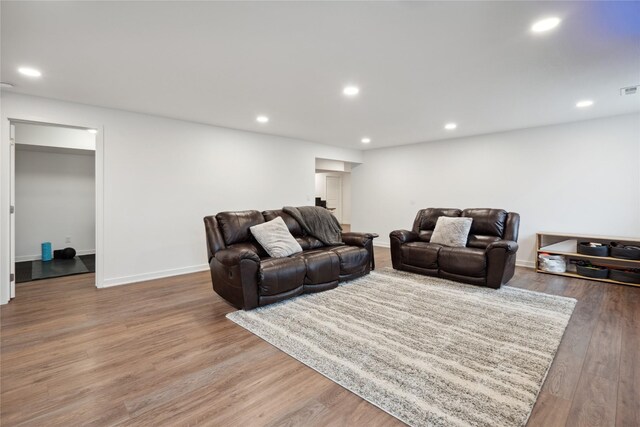 living room with recessed lighting, baseboards, visible vents, and wood finished floors