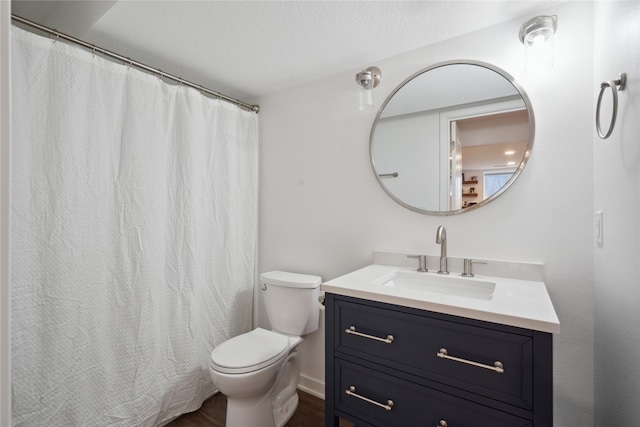 bathroom featuring wood finished floors, toilet, and vanity