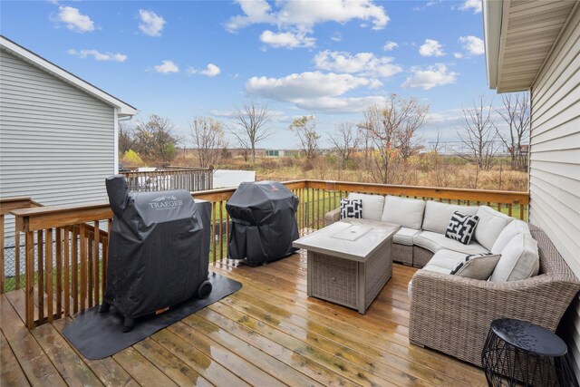 deck with grilling area and an outdoor living space