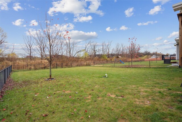 view of yard featuring a fenced backyard, a rural view, and a playground