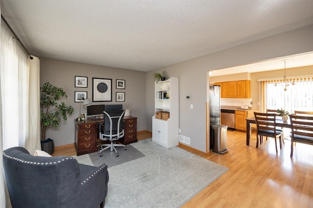 15026 Hawthorn Dr, Clive, IA 50325 - office area with a chandelier, light wood-style flooring, and baseboards