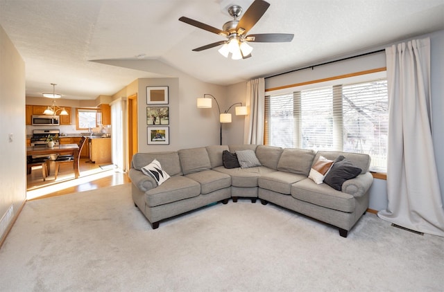 15026 Hawthorn Dr, Clive, IA 50325 - living area with vaulted ceiling, light carpet, and a ceiling fan