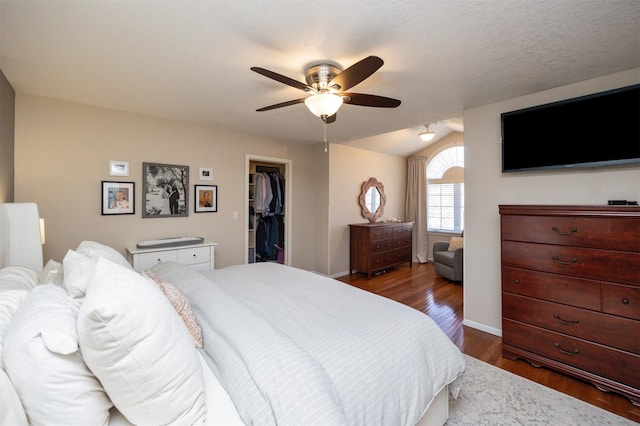 15026 Hawthorn Dr, Clive, IA 50325 - bedroom featuring a spacious closet, wood finished floors, a closet, and baseboards