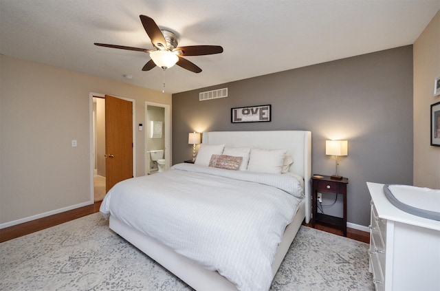 15026 Hawthorn Dr, Clive, IA 50325 - bedroom with baseboards, wood finished floors, ceiling fan, and ensuite bath