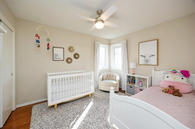 15026 Hawthorn Dr, Clive, IA 50325 - bedroom with baseboards, wood finished floors, and a ceiling fan